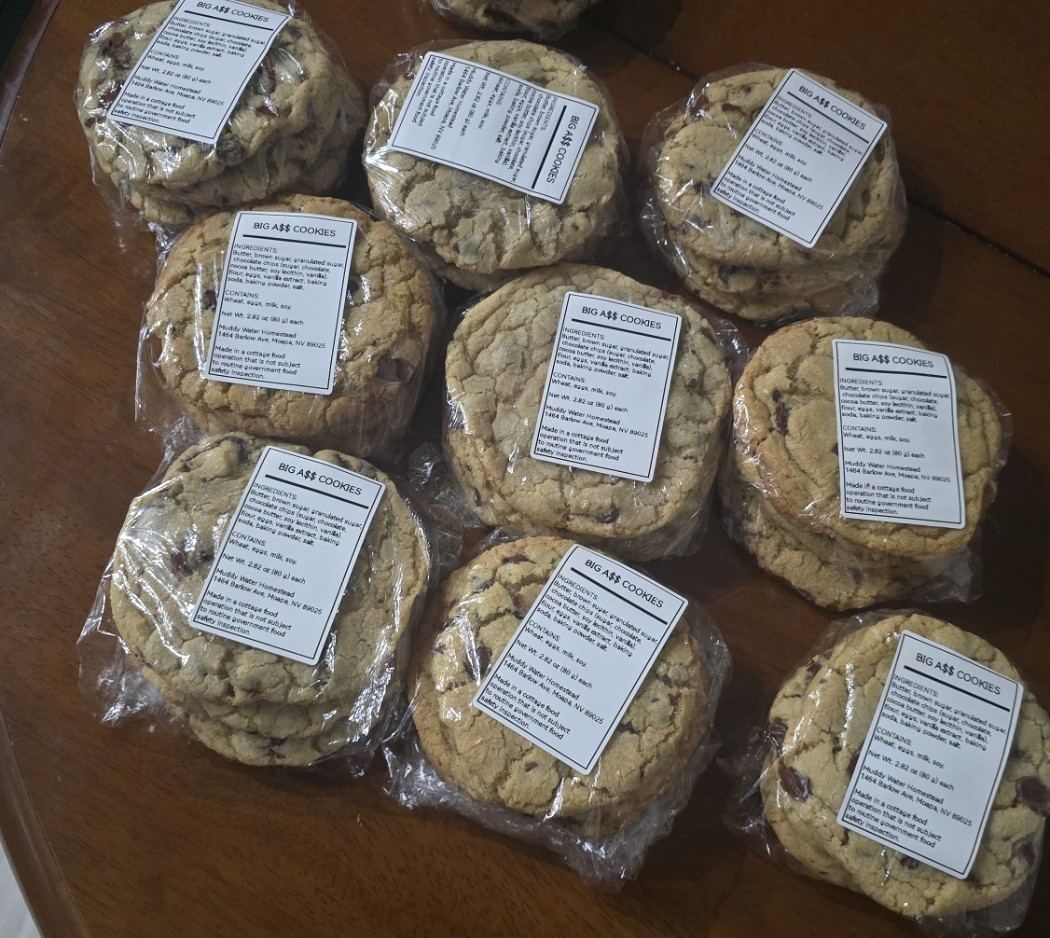 Wrapped and labeled cookies stacked on a table
